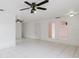 Spacious living room with tile flooring, ceiling fans, and arched openings at 3213 W Ivy St, Tampa, FL 33607