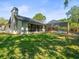 View of backyard, with screened in pool area and spacious yard at 3309 Westmoreland Dr, Tampa, FL 33618
