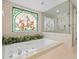 Luxurious bathroom with a soaking tub, glass-enclosed shower, and decorative stained glass for added charm at 3309 Westmoreland Dr, Tampa, FL 33618