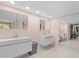 Modern bathroom featuring dual vanities, stylish wallpaper, and ample lighting for a spa-like experience at 3309 Westmoreland Dr, Tampa, FL 33618
