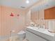 Elegant bathroom with sleek vanity, decorative wallpaper, and modern fixtures at 3309 Westmoreland Dr, Tampa, FL 33618