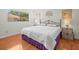 Bright bedroom with hardwood floors, window view, and decorative side tables at 3309 Westmoreland Dr, Tampa, FL 33618