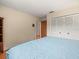 Spacious bedroom featuring parquet floors and bi-fold closet doors at 3309 Westmoreland Dr, Tampa, FL 33618