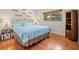 Comfortable bedroom with hardwood floors, window view, and a decorative quilt on the bed at 3309 Westmoreland Dr, Tampa, FL 33618