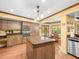 Bright kitchen with wood cabinets, island, stainless appliances, and adjacent breakfast nook at 3309 Westmoreland Dr, Tampa, FL 33618