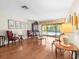 Spacious living room featuring hardwood floors and ample natural light, overlooking the pool area at 3309 Westmoreland Dr, Tampa, FL 33618