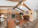 Inviting living room featuring a brick fireplace, wood beams, and hardwood floors at 3309 Westmoreland Dr, Tampa, FL 33618