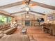 Comfortable living room with wood floors, a brick fireplace, and exposed wood beams at 3309 Westmoreland Dr, Tampa, FL 33618