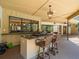 Outdoor bar area with granite countertops, seating for four, and a serene view of the lush backyard at 3309 Westmoreland Dr, Tampa, FL 33618