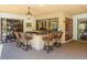Outdoor bar area with granite countertops, seating for four, and a serene view of the lush backyard at 3309 Westmoreland Dr, Tampa, FL 33618