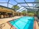 Beautiful screened pool and spa with an outdoor seating area and bar, perfect for entertainment at 3309 Westmoreland Dr, Tampa, FL 33618