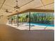 Spacious screened-in pool with ample deck space and tropical landscaping at 3309 Westmoreland Dr, Tampa, FL 33618