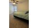 Bedroom featuring neutral carpeting, a ceiling fan, and a window, perfect for relaxation and restful sleep at 404 Lennox W Rd # 404, Palm Harbor, FL 34683