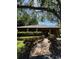 View of the community clubhouse with lush landscaping and a brick walkway leading up to the front entrance at 404 Lennox W Rd # 404, Palm Harbor, FL 34683