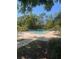 A spacious community pool is surrounded by lounge chairs and landscaping at 404 Lennox W Rd # 404, Palm Harbor, FL 34683