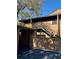 Condo exterior features a wood facade, stairs leading to the front door, and a carport with a covered parking spot at 404 Lennox W Rd # 404, Palm Harbor, FL 34683