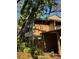 A charming two-story home with unique architectural details nestled among mature trees and lush greenery at 404 Lennox W Rd # 404, Palm Harbor, FL 34683