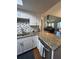 Kitchen view features granite counters, white cabinets, stainless steel appliances, and view into the living room at 404 Lennox W Rd # 404, Palm Harbor, FL 34683