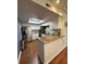 Bright kitchen features granite counters, white cabinets, tile backsplash, stainless steel appliances, and a skylight at 404 Lennox W Rd # 404, Palm Harbor, FL 34683