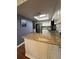 Bright kitchen features granite counters, white cabinets, tile backsplash, stainless steel appliances, and a skylight at 404 Lennox W Rd # 404, Palm Harbor, FL 34683