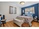 Bright bedroom with wood floors, a blue accent wall, white trim and large windows at 4160 30Th N St, St Petersburg, FL 33714