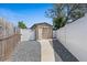 A gravel path between the house and vinyl fence leads to a storage shed at 4232 N Sandalwood Cir, Tampa, FL 33617