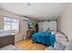This bedroom features wood flooring, white sliding closet doors, and a TV at 4232 N Sandalwood Cir, Tampa, FL 33617