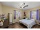 Cozy bedroom features wood-look floors, ceiling fan, two windows, and ample natural light at 4232 N Sandalwood Cir, Tampa, FL 33617