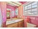 Bright bathroom with decorative stencil art and ample vanity storage at 4309 W Robin Ln, Tampa, FL 33609