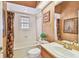 Cozy bathroom featuring a tub with shower, a wood vanity and a decorative paint scheme at 4309 W Robin Ln, Tampa, FL 33609
