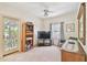 Cozy bedroom with a TV, a bookcase and a door to the outdoors at 4309 W Robin Ln, Tampa, FL 33609