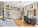 A bedroom with a desk, daybed, closet and walls filled with sports memorabilia and a window with shutters at 4309 W Robin Ln, Tampa, FL 33609