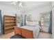 Bedroom with wood frame bed, side table, and natural light at 4309 W Robin Ln, Tampa, FL 33609