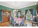 Traditional dining room featuring a wooden hutch, large windows and hardwood floors at 4309 W Robin Ln, Tampa, FL 33609