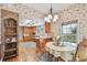 Cozy dining area open to kitchen with a brick accent wall and natural light from windows at 4309 W Robin Ln, Tampa, FL 33609