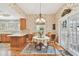 Charming dining area with floral wallpaper and natural light from two windows and glass doors at 4309 W Robin Ln, Tampa, FL 33609