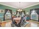 Formal dining room featuring hardwood floors, decorative accents, and large windows for natural light at 4309 W Robin Ln, Tampa, FL 33609