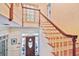 Grand entryway featuring a wooden door with glass detail, hardwood floors, and staircase at 4309 W Robin Ln, Tampa, FL 33609