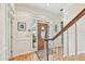 Bright foyer showcasing hardwood floors, a decorative front door, and staircase access at 4309 W Robin Ln, Tampa, FL 33609