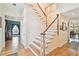 Open entryway showcasing hardwood floors, a staircase, and views into adjacent living spaces at 4309 W Robin Ln, Tampa, FL 33609