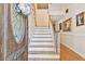 Bright foyer featuring a staircase, hardwood floors, and an elegant front door at 4309 W Robin Ln, Tampa, FL 33609