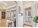 Inviting entryway with multiple glass doors leading to the outdoor spaces and light hardwood flooring at 4309 W Robin Ln, Tampa, FL 33609