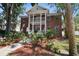 Charming brick facade with a welcoming porch, manicured landscaping, and mature trees at 4309 W Robin Ln, Tampa, FL 33609