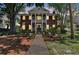 Elegant two-story brick home featuring a grand porch with classic columns and a well-manicured front yard at 4309 W Robin Ln, Tampa, FL 33609