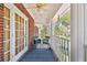 Welcoming front porch with brick floor, white columns and comfortable seating at 4309 W Robin Ln, Tampa, FL 33609