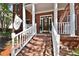Detailed view of the entryway with brick stairs, white railings, and decorative door wreath at 4309 W Robin Ln, Tampa, FL 33609