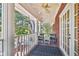 Charming front porch featuring classic white columns, brick floor and comfortable seating at 4309 W Robin Ln, Tampa, FL 33609