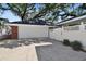 Spacious two-car garage with white door and adjacent fenced area, offering secure parking and additional privacy at 4309 W Robin Ln, Tampa, FL 33609