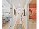 Hallway featuring hardwood floors, access to the powder room, and access to living room at 4309 W Robin Ln, Tampa, FL 33609