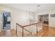 Elegant upstairs hallway featuring hardwood floors, chandelier and stairway at 4309 W Robin Ln, Tampa, FL 33609
